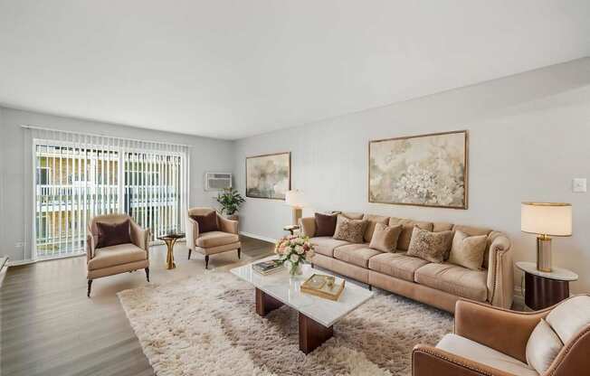 a living room with a couch and chairs and a coffee table