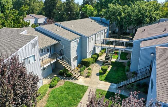 an aerial view of a row of houses with trees in the background at Silverstone Apartments, Davis, CA