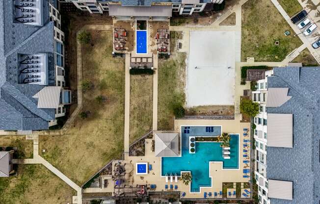 arial view of a house with a pool and a yard