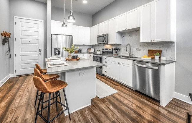 a kitchen with white cabinets and stainless steel appliancesat The Overlook, Florida