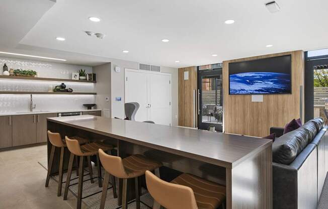 a kitchen with a bar and a living room with a couch