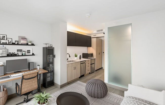 Model living and kitchen areas with office desk