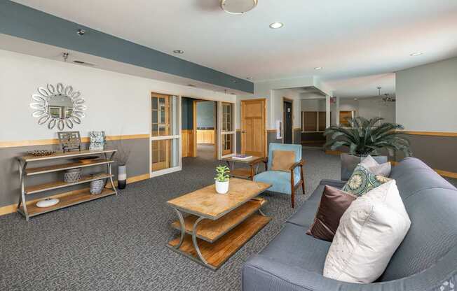 A living room with a grey couch and a wooden coffee table.