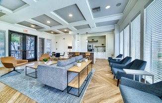A spacious waiting room with a variety of seating options and a view of the street outside.