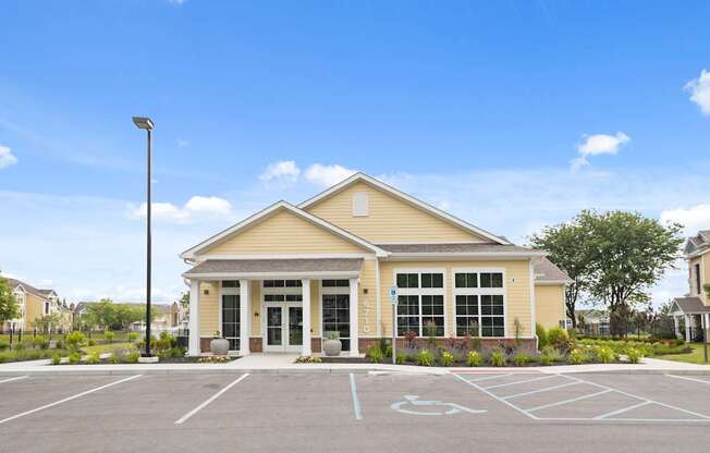 Front exterior of the Center Point Apartments leasing office building with ADA-accessible parking, fresh landscaping, and sunny weather.