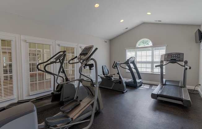 a gym with treadmills and other exercise equipment in a building