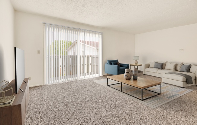 A living room with a blue chair and a white couch.