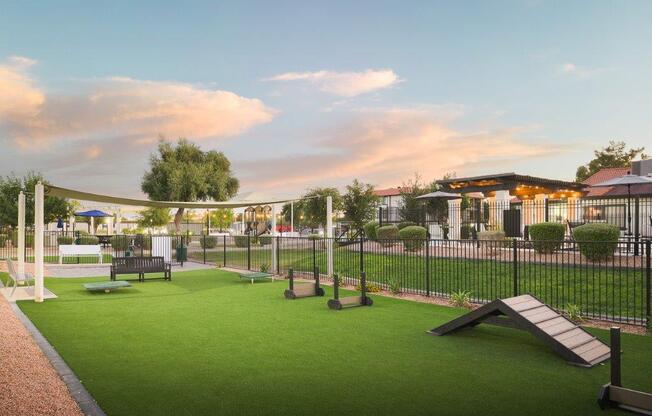 a dog park with agility courses and a fence