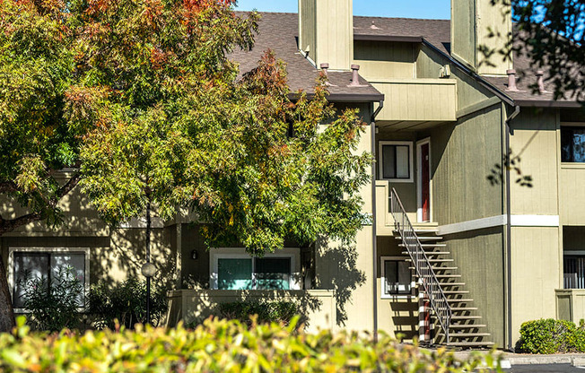 an aerial view of an apartment building with trees