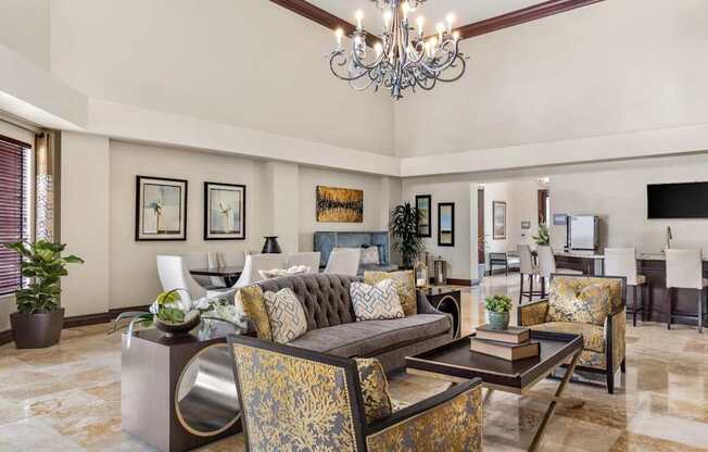 A living room with a chandelier, couches, and a coffee table.