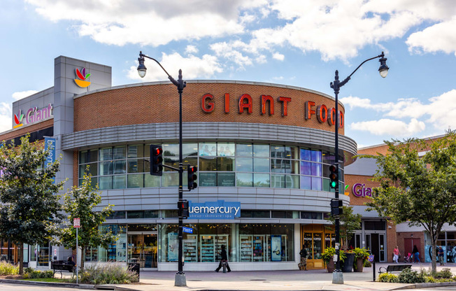 a large building with a giant corn sign on top of it on a city street