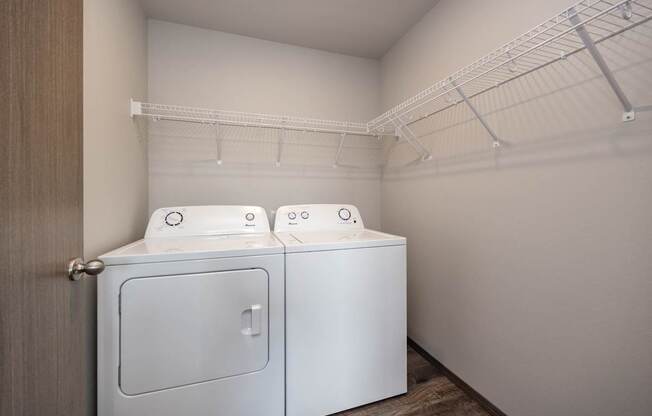 Two washing machines in a small laundry room.