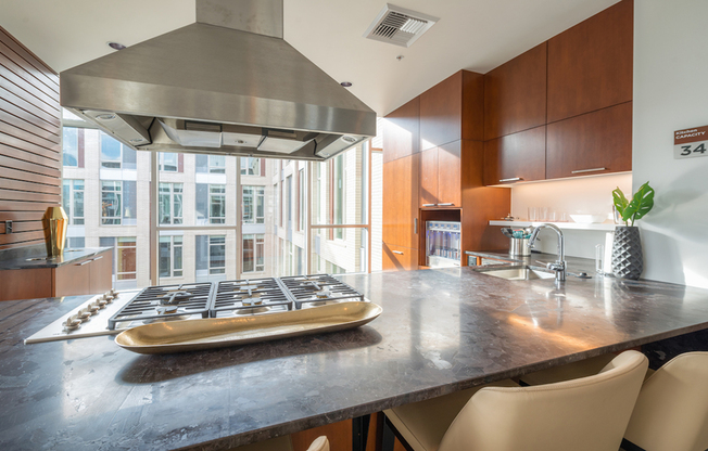 Demonstration kitchen with gas cooktop in the resident lounge