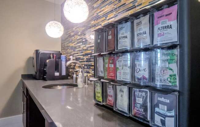 a bathroom counter with bags of coffee on it