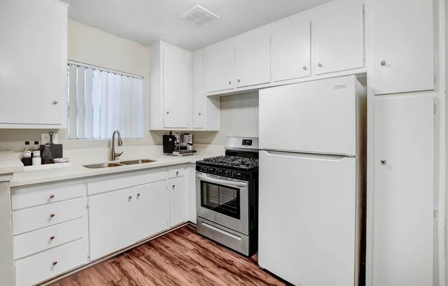 the preserve at ballantyne commons apartment kitchen with white cabinets and stainless steel appliances