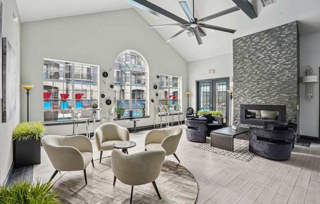 A modern living room with a fireplace and a view of a balcony.