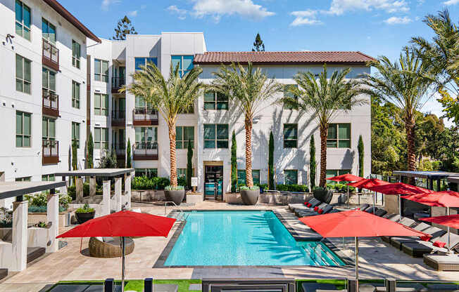 Shaded cabana seating with modern wicker furniture and ceiling fans for breezy afternoons by the pool