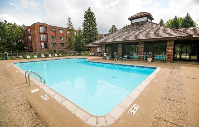 a pool with a brick building in the background