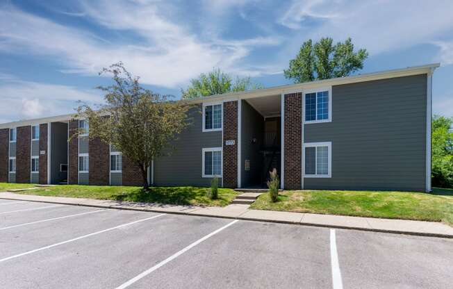 an exterior view of a building with a parking lot