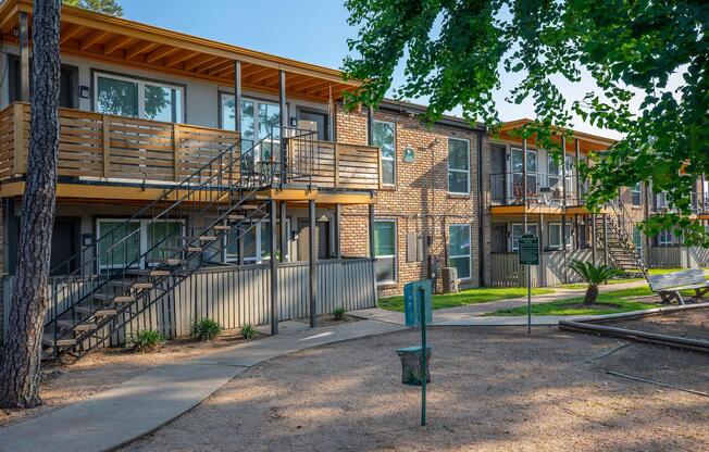 a house with a fence in front of a building