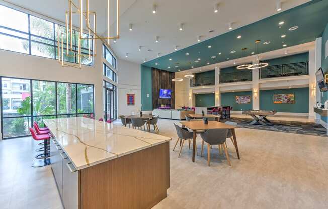 a large lobby with tables and chairs and a reception desk  at Pinnacle Apartments, Jacksonville, 32256