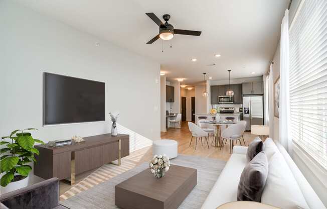 a living room with a white couch and a tv