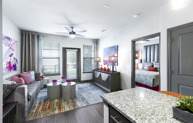 a living room with a kitchen and a bedroom at North Creek, Hutto, TX