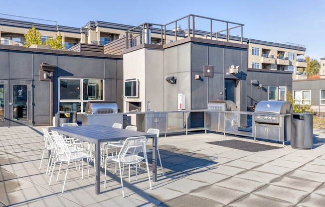 a patio with a table and chairs on the rooftop