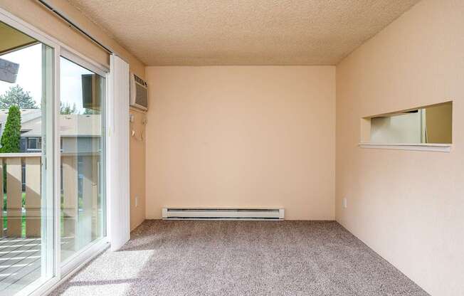A room with a carpeted floor and a window.