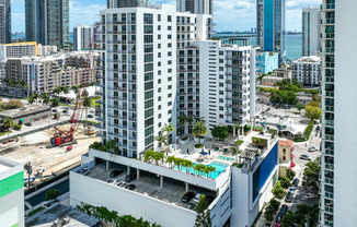 an aerial view of a city with tall buildings and a pool