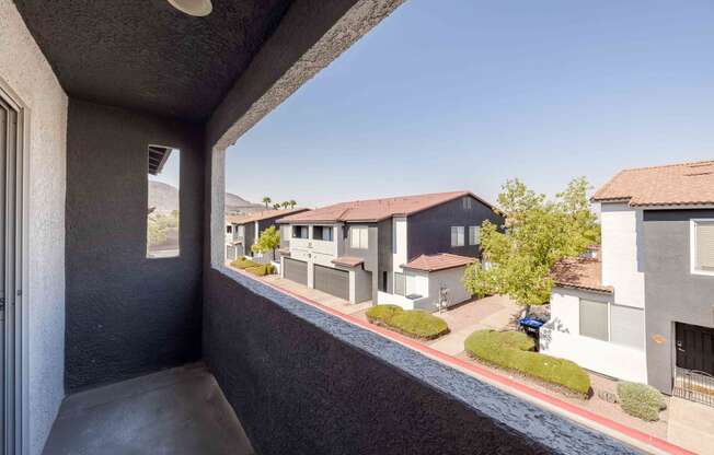 a balcony with a view of some houses and a street