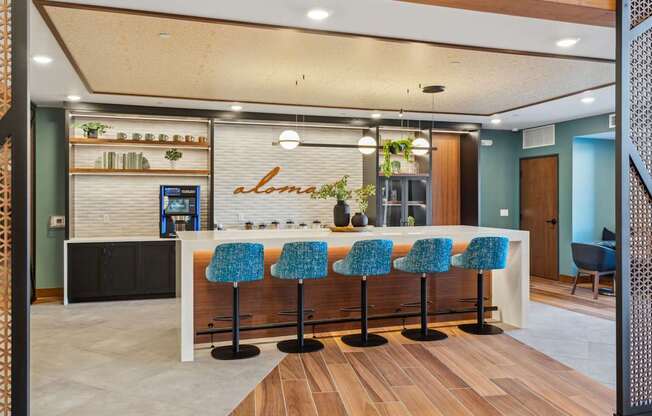 A bar area with blue chairs and a counter.