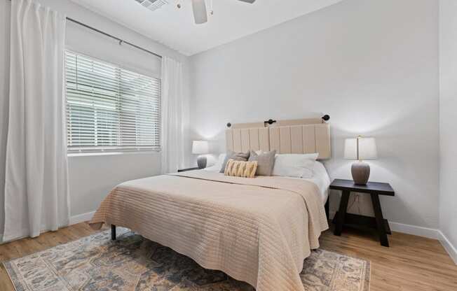 a bedroom with a large bed and a window