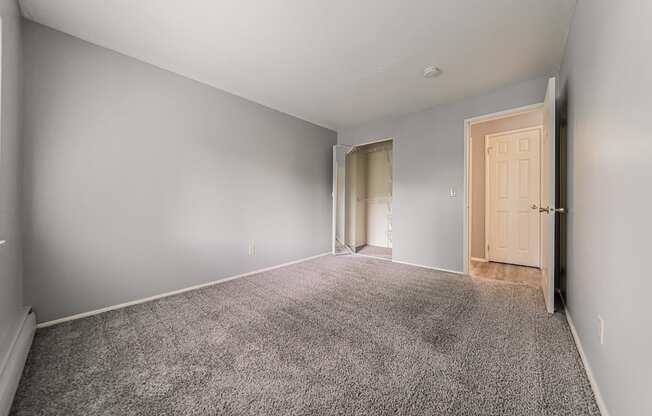 A room with grey carpet and white walls.