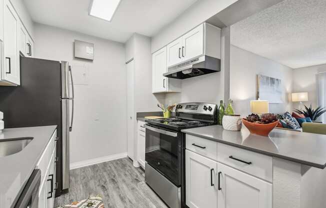 a kitchen with stainless steel appliances and white cabinets