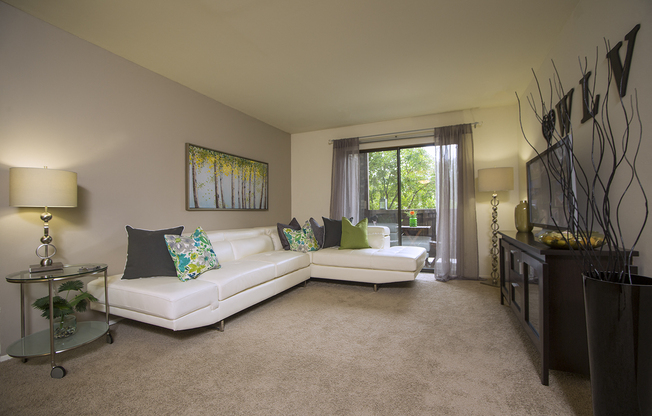 Spacious living room that accommodates large furniture at Woodland Villa Apartments in Westland, MI