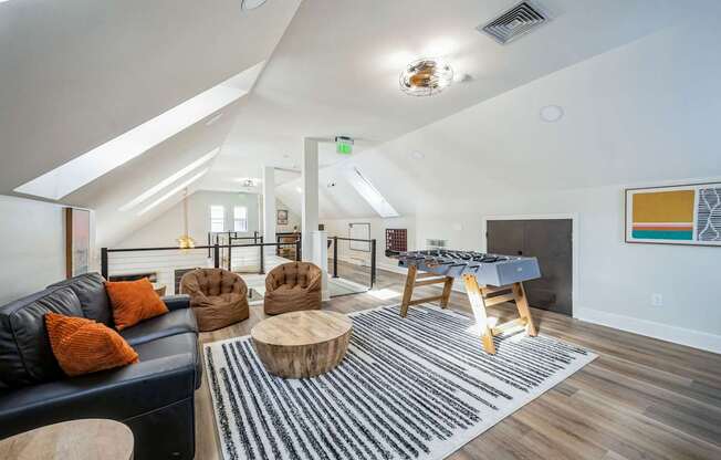A living room with a blue couch and a wooden coffee table.
