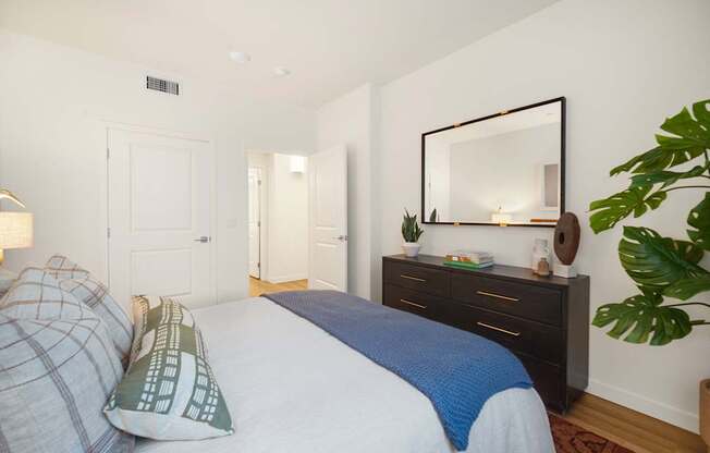 A bedroom with a bed, a dresser, and a mirror at The Villas at Anacapa Canyon, Camarillo, 93012