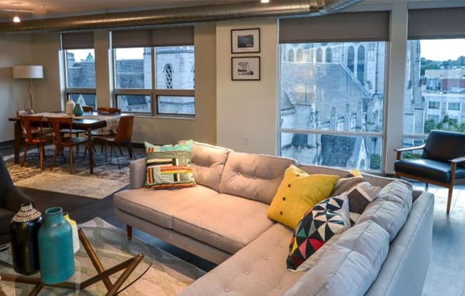 a living room filled with furniture and a large window