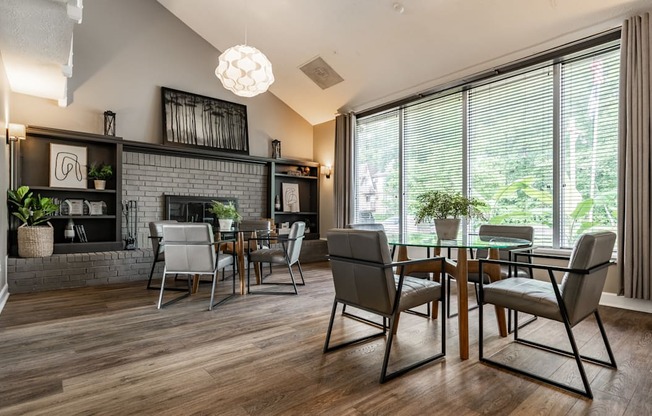 A modern dining room with a glass table and chairs