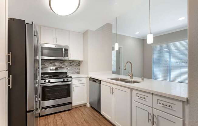 Our renovated kitchens open to the living room, creating a spacious flow—perfect for hosting guests and enjoying seamless entertaining at Ascent at the Galleria.