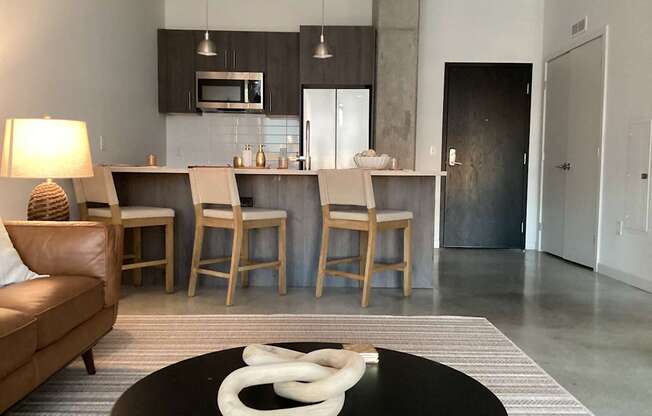 A modern living room with a black coffee table and a white sculpture on it.