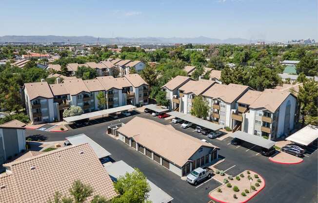 an aerial view of a group of houses in a parking lot