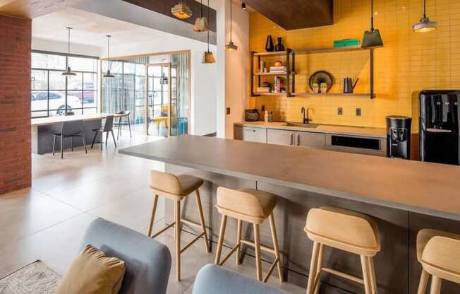 the kitchen and dining area of a modern house with yellow walls