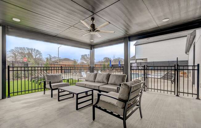 Outdoor covered patio with TV and pool views