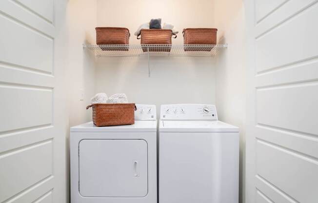 A white washing machine and dryer in a laundry room.