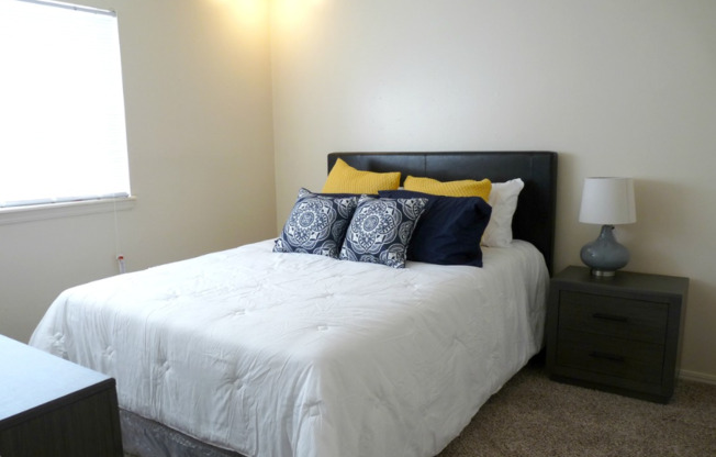 Image of large bed in carpeted bedroom