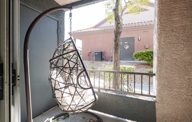 a hanging chair in front of a window