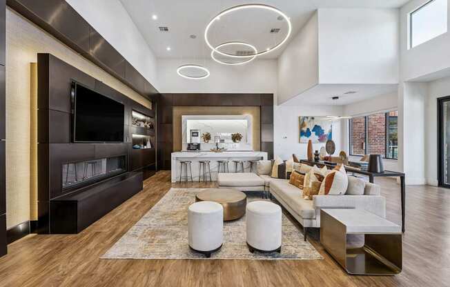 A modern living room with a dark brown entertainment center and a white sectional sofa.