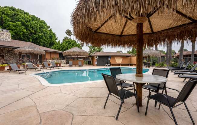 a pool with a table and chairs next to it